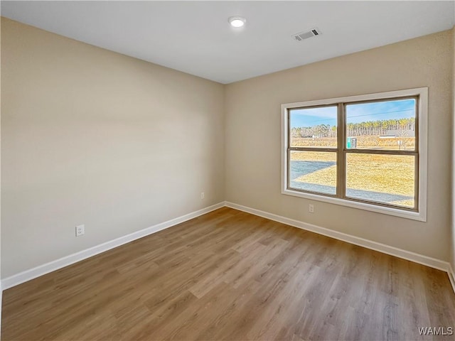 spare room featuring light hardwood / wood-style flooring