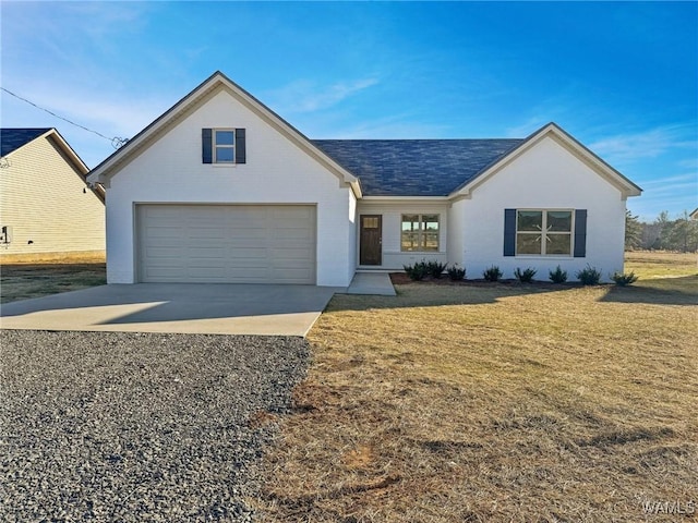 view of front of property with a garage and a front yard