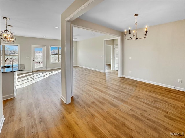 interior space with sink, light hardwood / wood-style flooring, and a notable chandelier