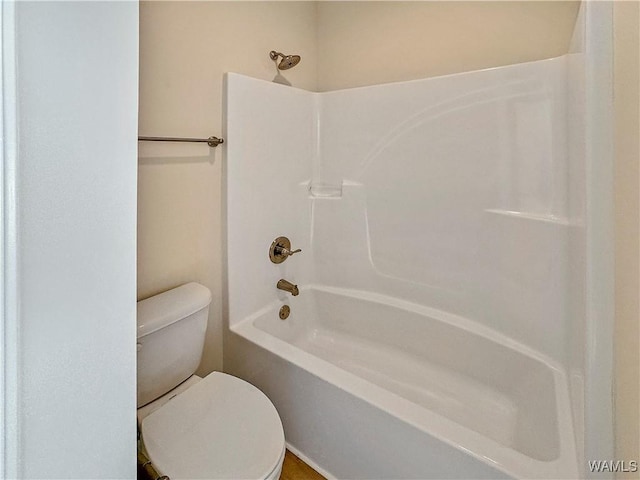 bathroom featuring washtub / shower combination and toilet