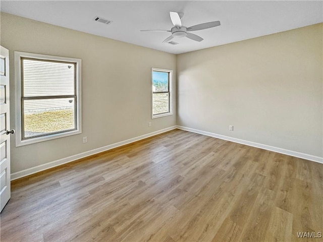 empty room featuring ceiling fan and light hardwood / wood-style floors