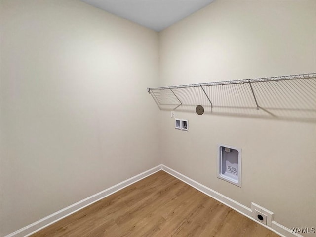 laundry room with hardwood / wood-style floors, hookup for a washing machine, and hookup for an electric dryer