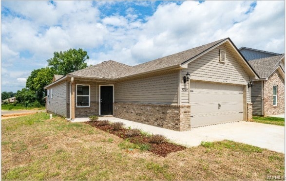 ranch-style house featuring a garage and a front lawn