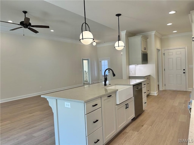 kitchen with dishwasher, sink, pendant lighting, a kitchen island with sink, and white cabinets