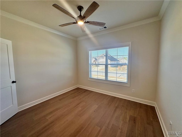 unfurnished room featuring dark hardwood / wood-style flooring, ceiling fan, and crown molding