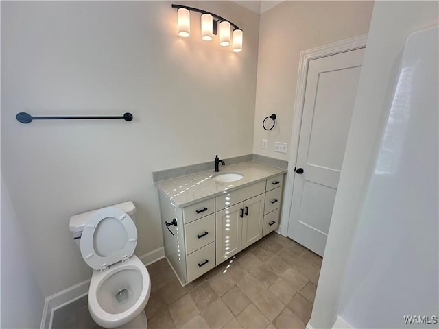 bathroom featuring tile patterned floors, vanity, and toilet