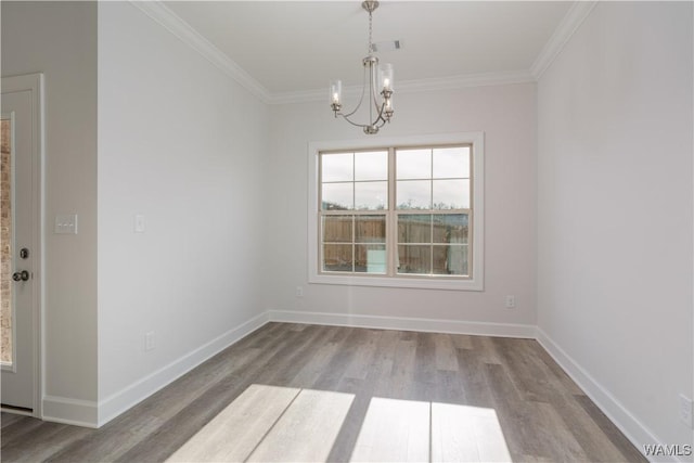 unfurnished dining area featuring wood finished floors, a chandelier, and ornamental molding