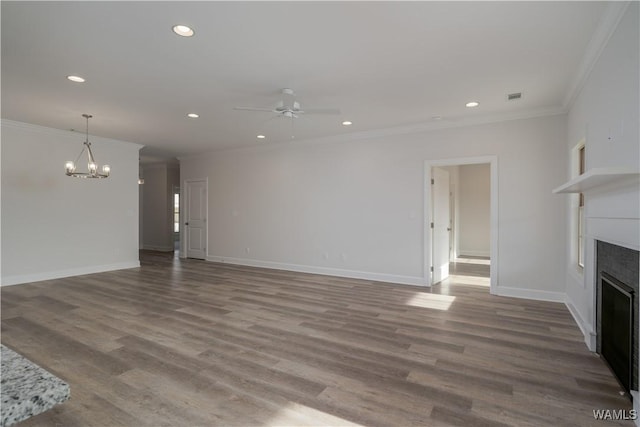 unfurnished living room featuring visible vents, ceiling fan with notable chandelier, wood finished floors, crown molding, and a fireplace