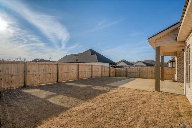 view of yard with a patio area and a fenced backyard