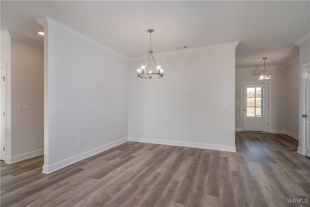 unfurnished room featuring visible vents, wood finished floors, crown molding, baseboards, and a chandelier