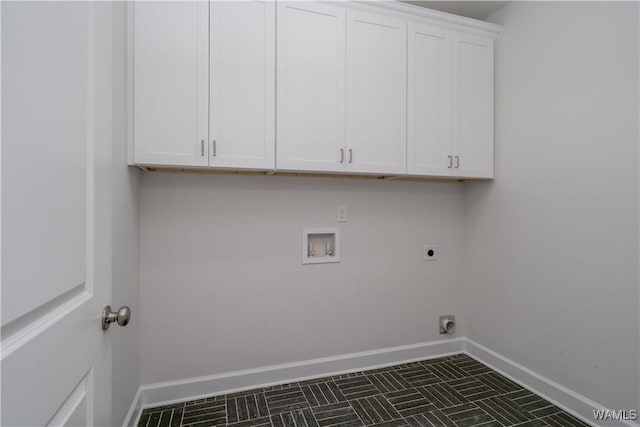 laundry area with cabinet space, electric dryer hookup, baseboards, and washer hookup