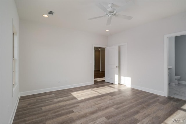 unfurnished bedroom with recessed lighting, wood finished floors, visible vents, and baseboards