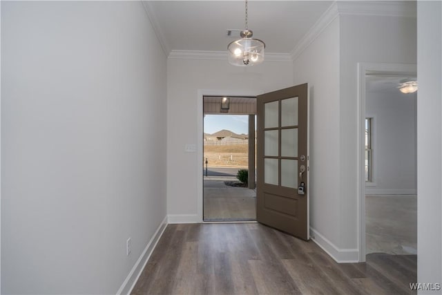 interior space with wood finished floors, baseboards, and ornamental molding