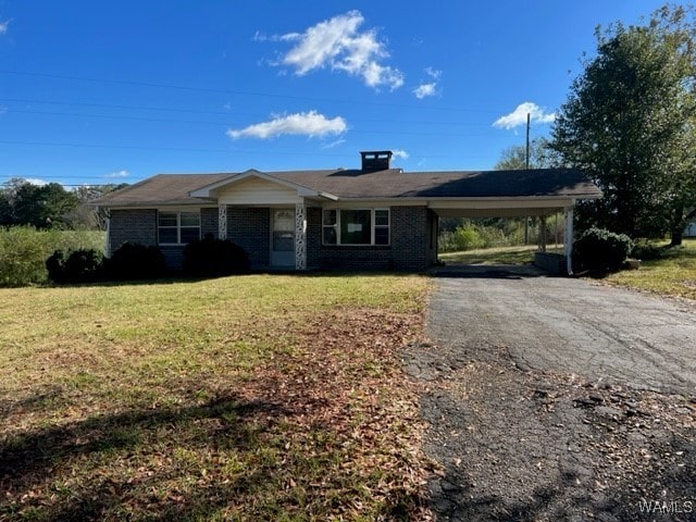 single story home featuring a carport and a front yard