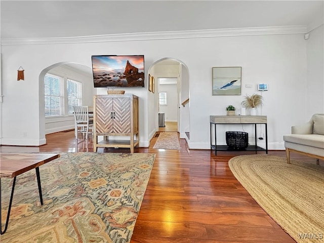 living room with hardwood / wood-style flooring and crown molding