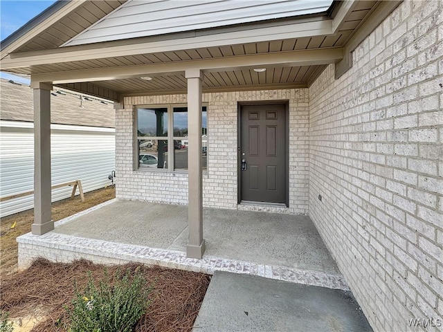 doorway to property with brick siding