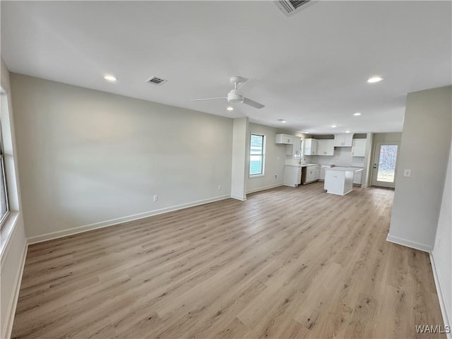 unfurnished living room featuring light wood finished floors, visible vents, baseboards, ceiling fan, and recessed lighting