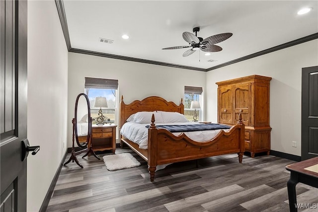 bedroom with dark wood-type flooring, multiple windows, visible vents, and baseboards