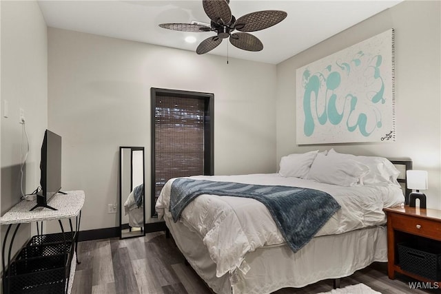 bedroom featuring dark wood-style floors, ceiling fan, and baseboards