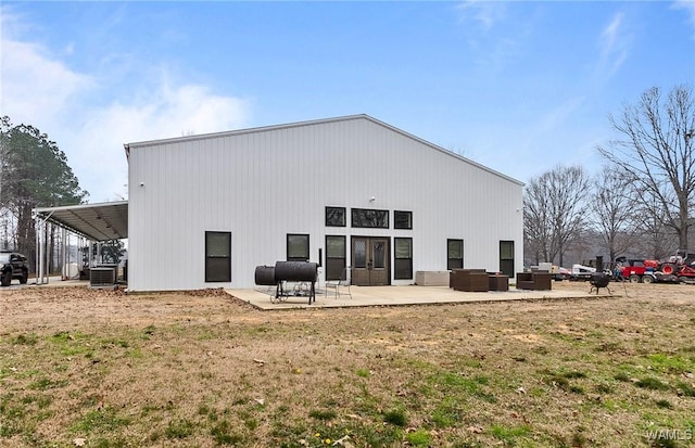 back of house with central AC, a patio, a lawn, and an outdoor hangout area