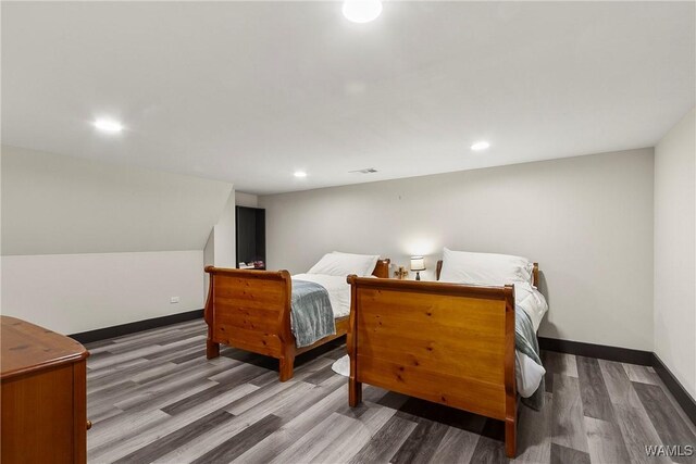 bedroom with recessed lighting, baseboards, and wood finished floors