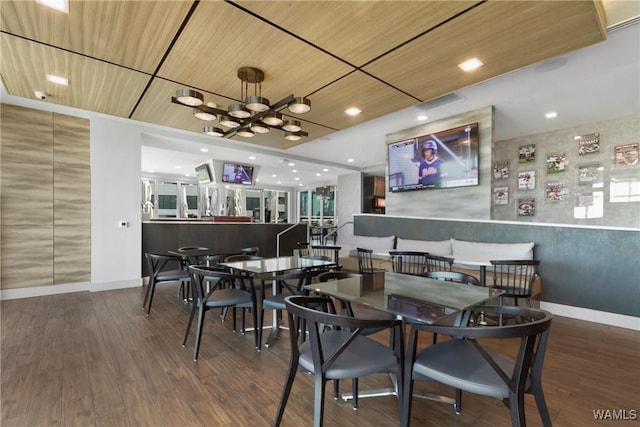 dining area with dark hardwood / wood-style flooring and wooden ceiling