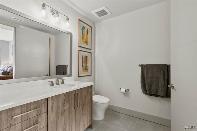 bathroom with vanity, toilet, and tile patterned flooring