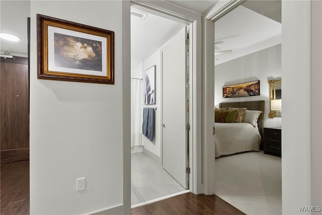 hallway with hardwood / wood-style flooring