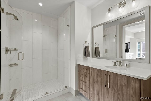 bathroom featuring vanity, an enclosed shower, and tile patterned floors