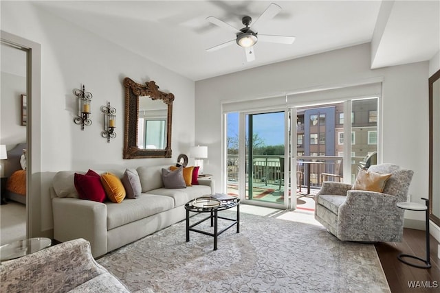 living room with ceiling fan and light hardwood / wood-style floors