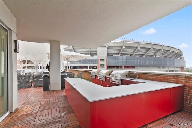 view of patio / terrace featuring area for grilling, grilling area, and a wet bar