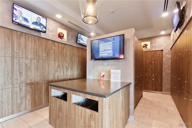 interior space with light tile patterned flooring and wooden walls