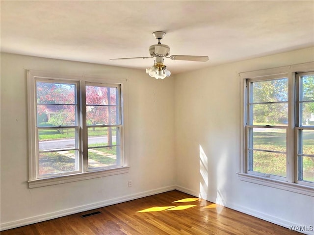 empty room featuring hardwood / wood-style flooring and ceiling fan