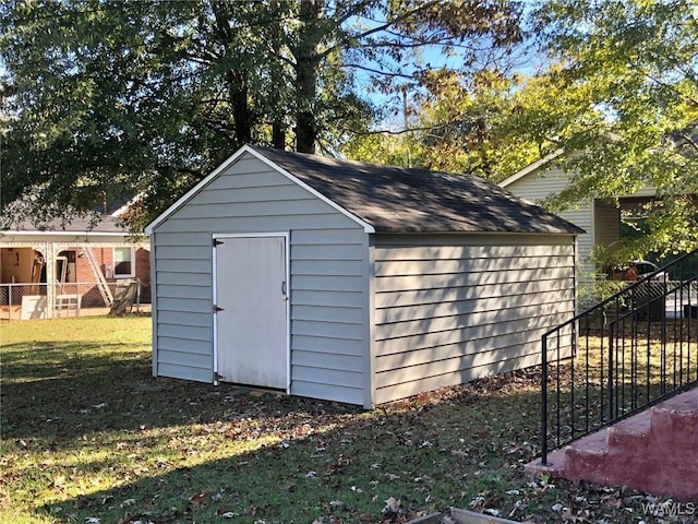 view of outbuilding with a lawn