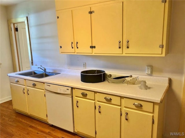 kitchen with sink, white dishwasher, and light wood-type flooring