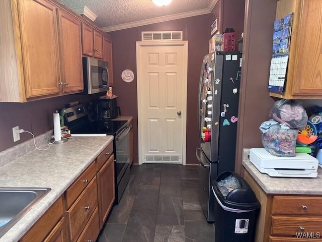 950 Pine Tree Rd, Centreville, AL 35042 - kitchen featuring stainless steel appliances, brown cabinets, ornamental molding, light countertops, and a textured ceiling