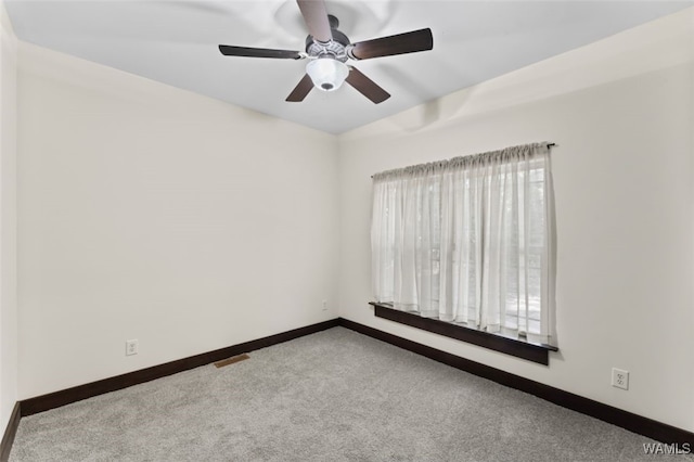 carpeted empty room featuring ceiling fan