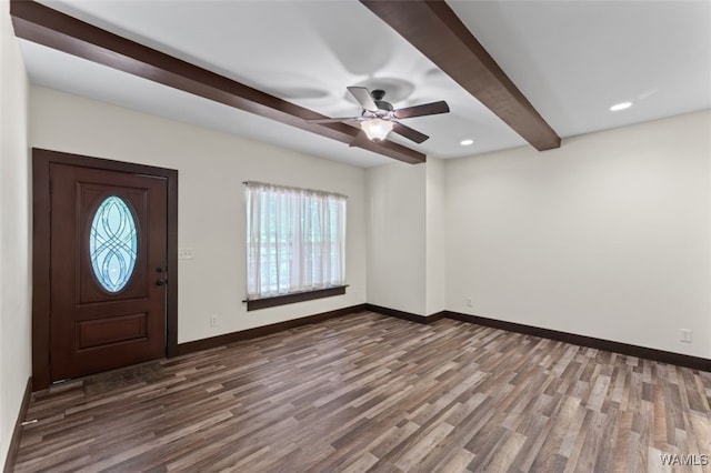 foyer with beamed ceiling, ceiling fan, dark wood-type flooring, and a wealth of natural light