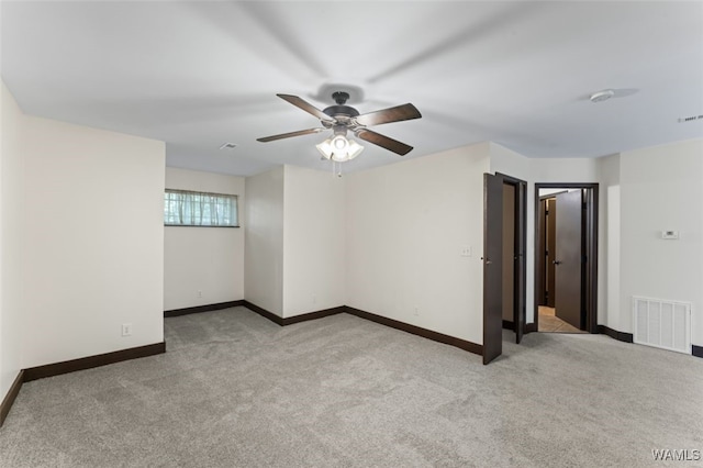 carpeted spare room with ceiling fan