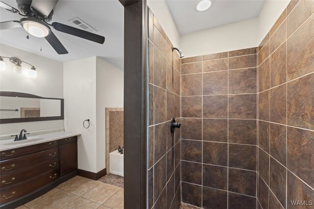 bathroom with tile patterned floors, vanity, ceiling fan, and shower with separate bathtub