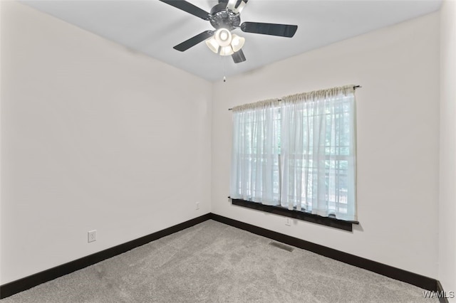 empty room with light colored carpet and ceiling fan