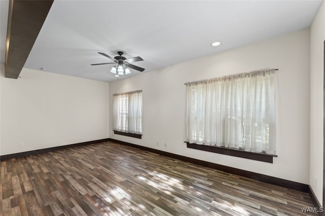 unfurnished room with ceiling fan and dark hardwood / wood-style flooring