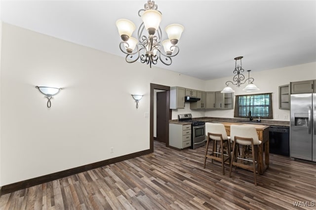 kitchen featuring gray cabinetry, decorative light fixtures, dark hardwood / wood-style flooring, stainless steel appliances, and a chandelier