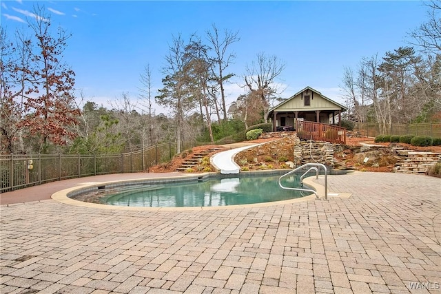 view of pool with a fenced in pool, a patio, stairway, a water slide, and fence