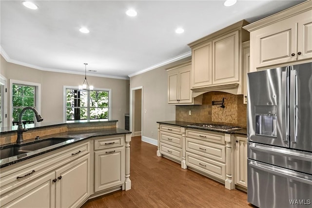 kitchen featuring a sink, tasteful backsplash, cream cabinets, and stainless steel appliances