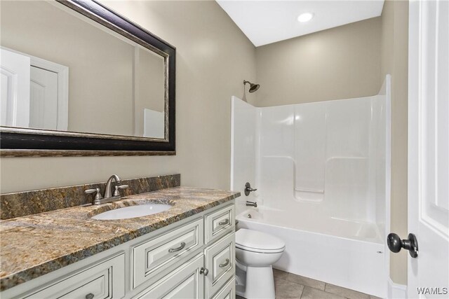 bathroom featuring toilet, shower / bath combination, vanity, and tile patterned flooring