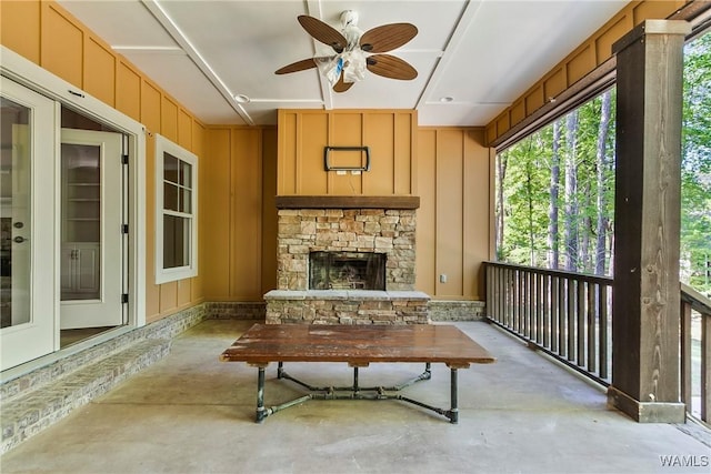 view of patio / terrace with ceiling fan and a fireplace