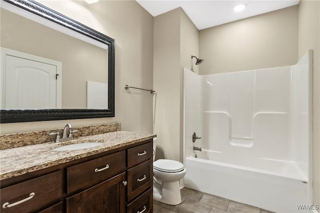bathroom featuring toilet, vanity, tile patterned flooring, and shower / washtub combination