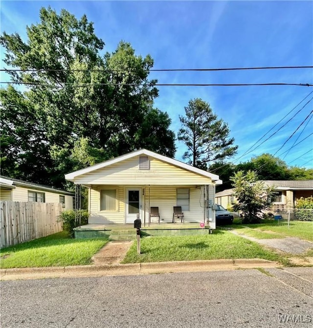 bungalow featuring a porch and a front lawn