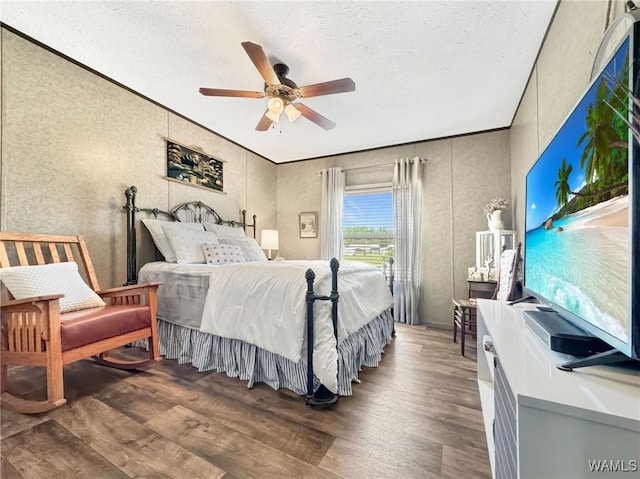 234 Broad Leaf Cir, Moundville, AL 35474 - bedroom featuring wood finished floors, a textured ceiling, and a ceiling fan